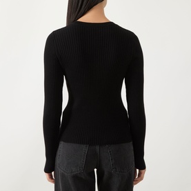 Model wearing Barbour International Kyla Logo Rib-Knit Sweater in black, back view, showing rib-knit texture and long sleeves, styled with grey jeans.