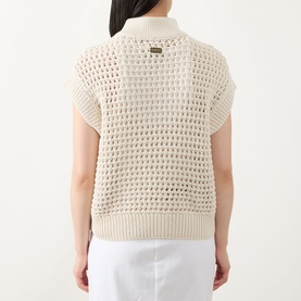 Model wearing Barbour International Light Stone open-knit cotton sleeveless jumper, back view, styled with white trousers