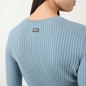 Model wearing Barbour International Seren Rib-Knit Sweater in Washed Pearl Blue, showing rear logo badge and ribbed cotton construction.