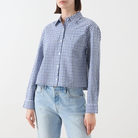 Model wearing Barbour Ashwell Gingham Shirt in blue multi gingham, cropped fit, long sleeves, button front, styled with light wash jeans.