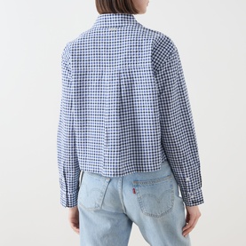 Model wearing Barbour Ashwell Gingham Shirt in blue multi gingham, back view showing pleat detail, styled with light blue denim jeans.