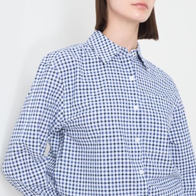 Model wearing Barbour Ashwell Gingham Shirt in blue multi gingham, showing pointed collar and button fastening detail.