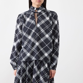 Model wearing Barbour Bailton Tartan Blouse in Dark Navy/White Check with ruffle collar, tie fastening, and long blouson sleeves. Styled with