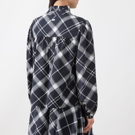 Model wearing Barbour Bailton Tartan Blouse in Dark Navy/White Check, showing rear view with ruffle collar and blouson sleeves.