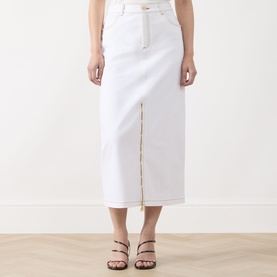 Model wearing Barbour International Kyla Denim Skirt in Denim White, midi length with front zip split and contrast stitching, styled with strappy