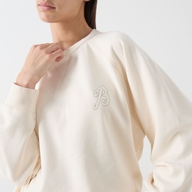 Model wearing Barbour ecru cotton sweat top with tonal embroidered B logo detail on chest, relaxed fit, crew neck