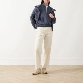 Model wearing Barbour International Odyssey sweat in navy, styled with cream trousers and beige boots