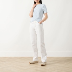 Model wearing Barbour International Pearl Blue cotton T-shirt, styled with white straight-leg jeans and beige espadrilles.