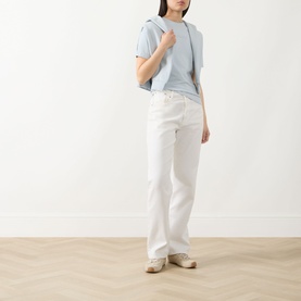 Model wearing Barbour International Pearl Blue cotton T-shirt, styled with white wide-leg jeans and beige flat shoes.