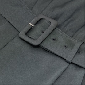 Reiss dark grey dress detail showing wide matte buckle belt with double-button fastening and structured fabric panels.
