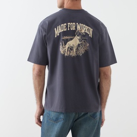 Model wearing Levi's Made For Workin Crew Neck T in Periscope grey, back view showing graphic print with dog illustration and slogan