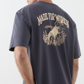 Model wearing Levi's Made For Workin Crew Neck T in Periscope grey, back view showing dog and field graphic print.