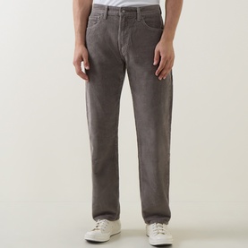 Model wearing Levi's 555&trade; Corduroy Relaxed Straight Jeans in Smokey Taupe, mid-rise straight leg fit, styled with white trainers.