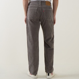 Model wearing Levi's 555&trade; Corduroy Relaxed Straight Jeans in Smokey Taupe, showing rear view with logo patch and contrast stitching.