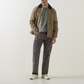 Model wearing Levi's 555&trade; Corduroy Relaxed Straight Leg Jeans in Smokey Taupe, styled with a tan jacket and striped knit top.