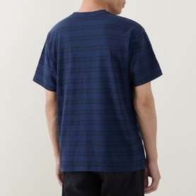 Model wearing Levi's Grady Chevron Stripe Dress Blues crew neck T-shirt, rear view, navy horizontal stripe cotton tee, short sleeves.