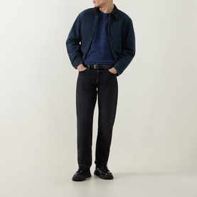 Model wearing Levis Grady Chevron Stripe Dress Blues Crew Neck T, styled with navy jacket, black jeans and black leather shoes.