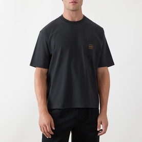 Model wearing Levis Workwear Pocket Logo T-Shirt in Jet Black with crew neck, dropped shoulders, and chest patch pocket logo badge.