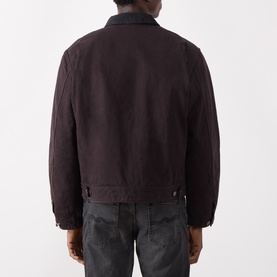 Model wearing Nudie Jeans Dark Brown casual jacket in 100% cotton, rear view, styled with dark grey jeans.
