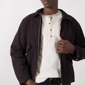 Model wearing Nudie Jeans Dark Brown cotton casual jacket, styled over a cream henley T-shirt