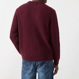 Model wearing Nudie Jeans August Rib Sweater in Burgundy, ribbed wool crew neck, back view, styled with light blue jeans.