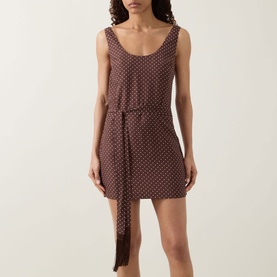 Model wearing Posse Evie Polka Dot Belted Mini Dress in Choc Vanilla, sleeveless scoop-neck mini with tie belt and straight hem.
