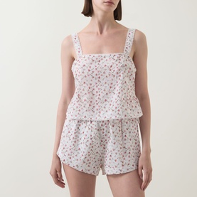 Model wearing Posse Watercolour Floral cotton camisole top with square neck and matching floral shorts