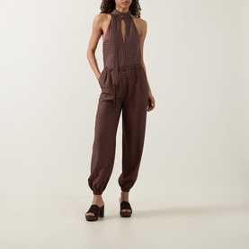 Model wearing Posse Phoebe Polka Dot Blouse in Choc Vanilla with matching trousers, styled with dark brown platform mule sandals.