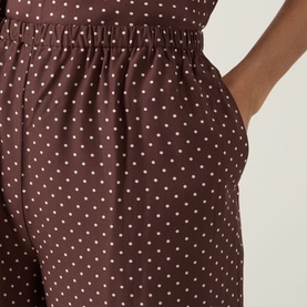 Model wearing Posse Evie Polka Dot Trousers in Choc Vanilla, showing elasticated waistband, side pocket and polka dot print detail.