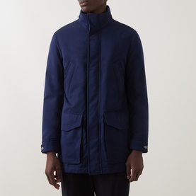 Model wearing B Cucinelli navy casual jacket with funnel neck, front flap pockets, and snap-button placket detail.