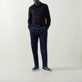 Model wearing Brunello Cucinelli navy calf suede casual jacket, styled with navy trousers and navy leather trainers.