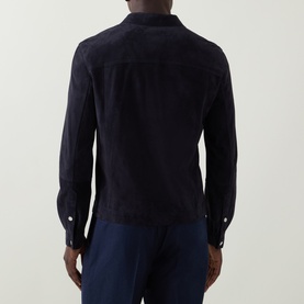 Model wearing B Cucinelli navy calf suede casual jacket, back view, styled with navy trousers