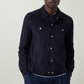 Model wearing Brunello Cucinelli navy suede casual jacket with silver snap buttons and chest pockets, styled with navy trousers