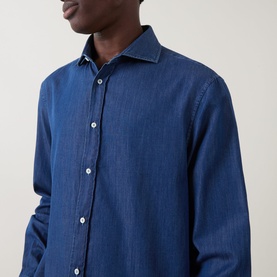 Model wearing B Cucinelli dark wash denim casual shirt in 100% cotton, featuring spread collar and button placket, close-up view