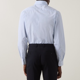 Model wearing B Cucinelli blue cotton casual shirt, rear view, styled with navy trousers