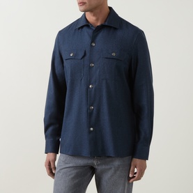 Model wearing Brunello Cucinelli blue virgin wool casual shirt with twin chest pockets and button fastening, styled with grey jeans