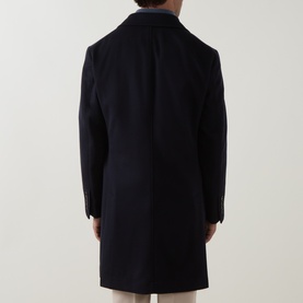 Model wearing B Cucinelli navy 100% virgin wool coat, rear view showing clean back seam and below-knee length