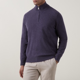 Model wearing B Cucinelli violet cashmere half-zip jumper with silver zip detail, styled with beige trousers