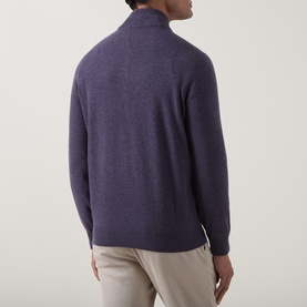 Model wearing Brunello Cucinelli violet cashmere half-zip jumper, shown from behind, styled with light beige trousers.
