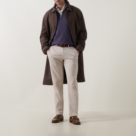 Model wearing Brunello Cucinelli violet cashmere half-zip, styled with dark brown overcoat, light trousers and brown loafers.