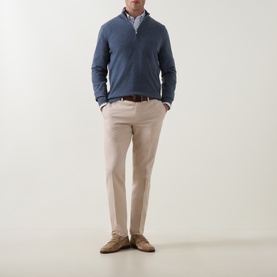 Model wearing B Cucinelli blue cashmere half-zip jumper, styled with beige chinos, striped shirt, and tan suede loafers.