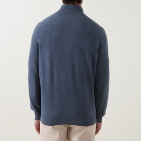 Model wearing B Cucinelli blue cashmere half-zip jumper, back view, styled with stone chinos
