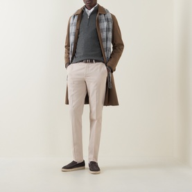 Model wearing Brunello Cucinelli Dark Green Cashmere Half Zip, styled with brown overcoat, plaid scarf, stone trousers and navy loafers