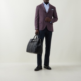 Model wearing B Cucinelli purple silk-wool-cashmere jacket, styled with navy trousers and white shirt, carrying a dark tote bag.