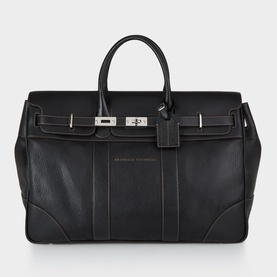 B Cucinelli Logo Grained Leather Holdall in black with silver-tone hardware, turn-lock flap closure, double top handles, and contrast stitching
