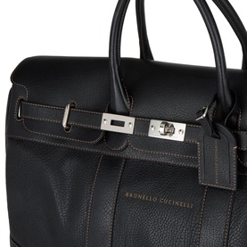 Brunello Cucinelli Logo Grained Leather Holdall in black with silver-tone hardware, turn-lock closure, double handles, and contrast stitching
