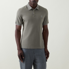 Model wearing Brunello Cucinelli Logo Pique Polo Shirt in Army Wash, with polo collar, tipped cuffs and chest logo, styled with grey trousers