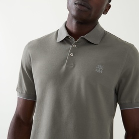 Model wearing Brunello Cucinelli Logo Pique Polo Shirt in Army Wash, featuring tonal logo embroidery and button fastenings at collar.