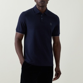 Model wearing Brunello Cucinelli Logo Pique Polo Shirt in Cadet navy, featuring polo collar, short sleeves and tonal logo detail.