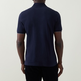 Model wearing B Cucinelli Logo Pique Polo Shirt in Cadet, back view showing polo collar, short sleeves and straight hemline